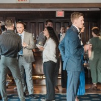 Group of GVSU Alumni in groups mingling and talking to each other